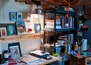 Chris Thornock’s Studio, shelves, books, paintings, photo by Gerry Johnson